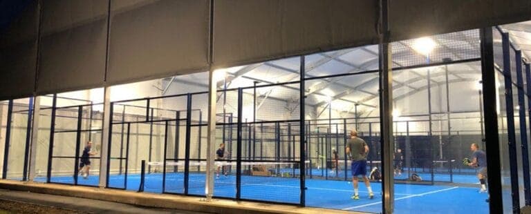 Undercover padel courts at Padel4all Basset Down with people playing, showcasing the club’s lively atmosphere and high-quality all-weather facilities in Basset Down, Wiltshire.