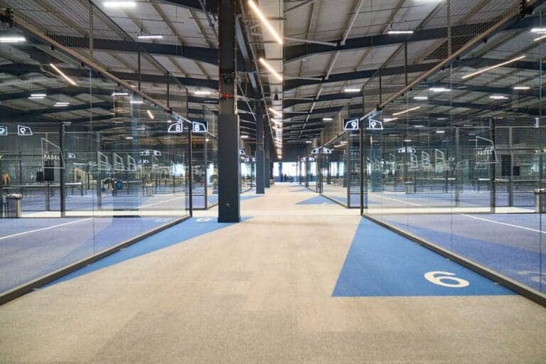 The Padel Club Gloucester Quays image showing multiple indoor padel courts with high ceilings and modern facilities, highlighting one of the UK’s largest indoor padel venues located at Gloucester Quays.