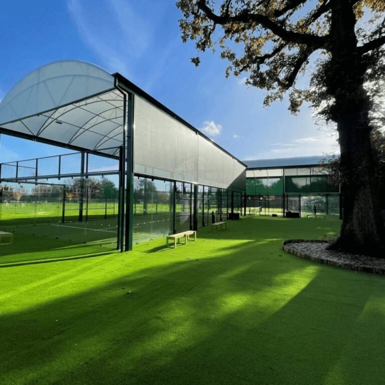 Two undercover padel courts at The West Worthing Club with a beautiful tree nearby, highlighting the club’s blend of modern facilities and natural surroundings in Worthing, West Sussex.