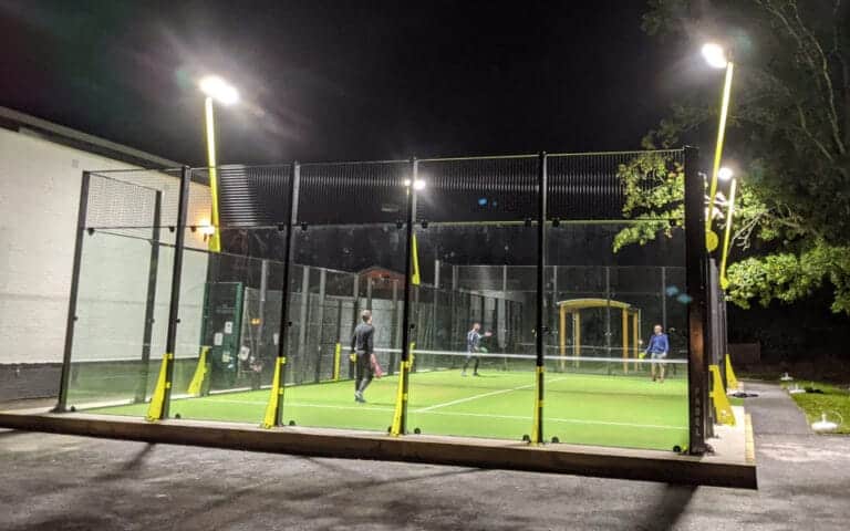 Ashtead Squash & Tennis Club – players on an outdoor court at night under floodlights at a community racquets club in Surrey
