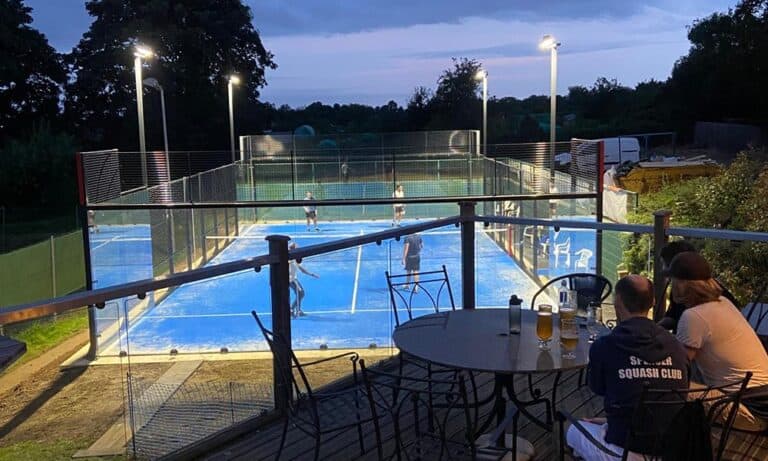 Northampton County Lawn Tennis Club – outdoor tennis courts at night with players in action under floodlights