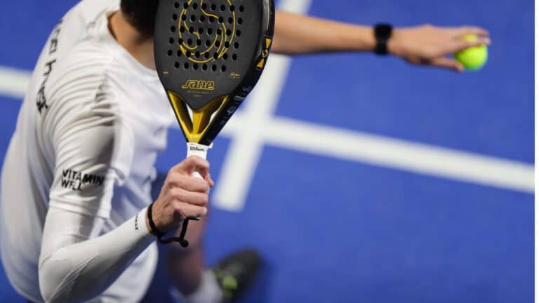 Core Padel Birmingham – man preparing to hit a shot with padel racket on court, showcasing dynamic play and modern club environment