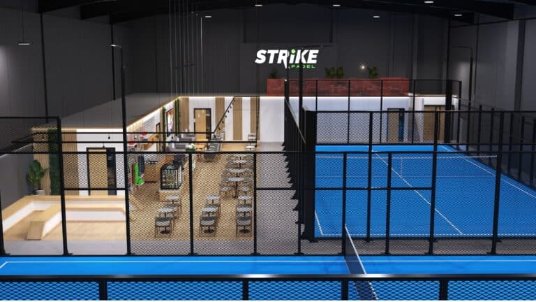 Strike Padel Bradford – wide-angle view showing five indoor panoramic padel courts alongside the modern café and seating area